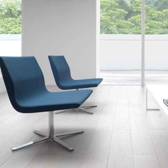 Camilla lounge chair. Fully-upholstered teal blue shell on swivel base