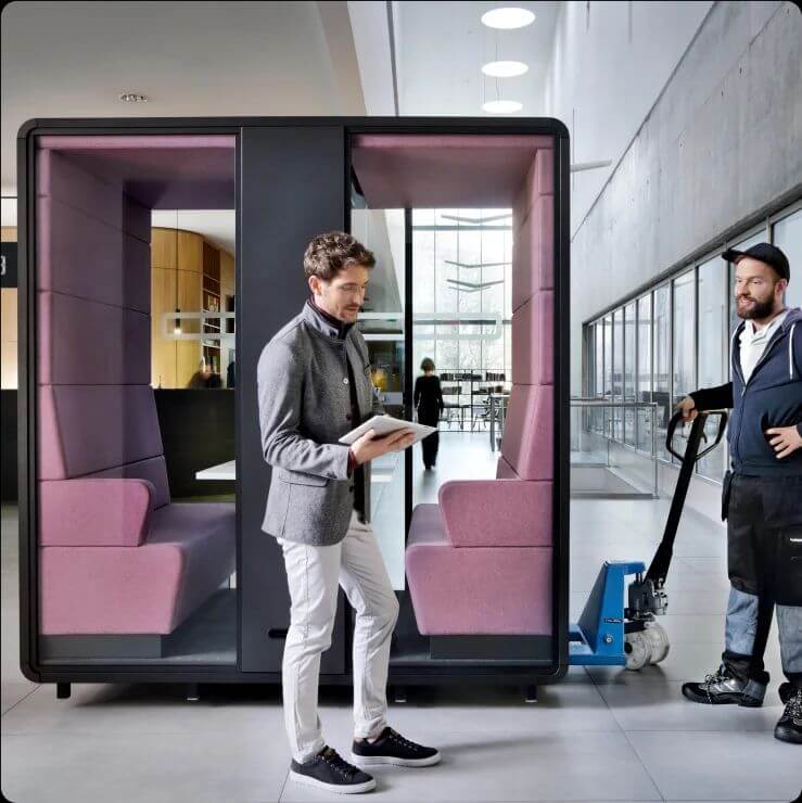 Hush Meet on trolley showing mobility in setting, with person in front indicating office space and person moving trolley